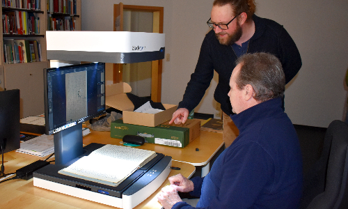 Projektmitarbeiter Martin Müller führt Ortschronist Wolfgang Kapfenberger in die Arbeit mit dem digitalen Buchscanner ein (C) privat